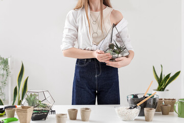 Woman with florarium at home, closeup