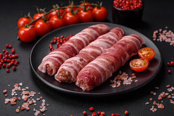 Raw minced meat wrapped in bacon with salt and spices or cevapcici