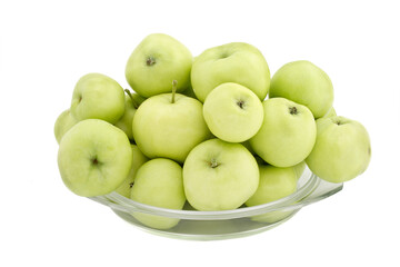 Green apples in a glass plate on a white background