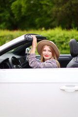Portrait of Young girl driving cabriolet
