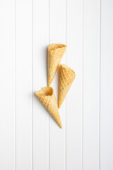 Empty wafer cone. Sweet ice cream cornet on kitchen table. Top view.