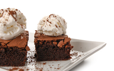 Plate with pieces of tasty chocolate brownie and ice cream on white background, closeup