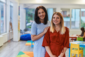 Portrait of a two teacher in a preschool institution, in the background of the classrooms