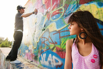 Young couple in a graffiti background
