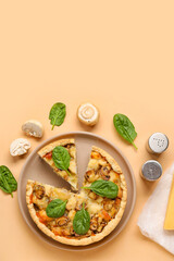 Mushroom pie with spinach leaves and champignons on beige background