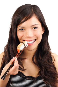 Sushi. Woman eating nigiri sushi with shrimp closeup. Beautiful model.
