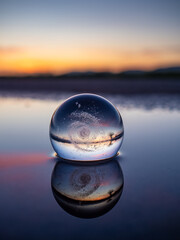 crystal ball with Galaxy Milky Way on lake  at sunset