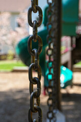 Chain link in front of a playground slide in suburban New Jersey 