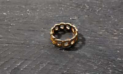 Beautiful ring on black wooden background