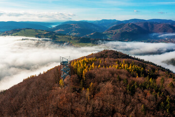 Aerial Drone Shot: Sightseeing Tower in Brezno, Autumn Scenery with Misty Morning and Cloud...