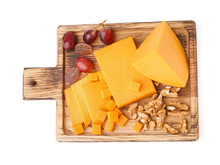 Wooden board with tasty cheddar cheese, grapes and nuts on white background