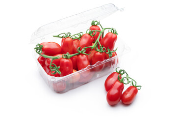 Datterini tomatoes in transparent plastic container isolated on white background..