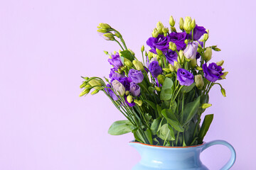 Naklejka na ściany i meble Jug with eustoma flowers on lilac background