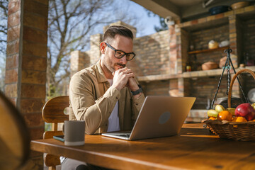 man caucasian work on laptop computer on terrace happy smile success