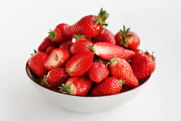 Bowl with fresh strawberries on white background