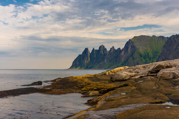 Fototapeta na wymiar The Tungeneset (Devil's Teeth), mountains over the ocean in Senja Island, Norway