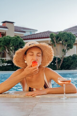 Portrait of laughing beautiful woman in swimwear relaxing in swimming spa pool.