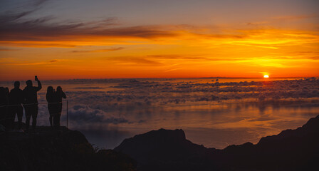 Silhouette of People watching Sunrise above clouds II.