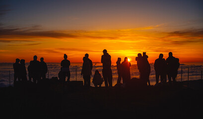 Silhouette of People watching Sunrise above clouds I.