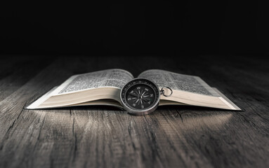 Book and compass on the table