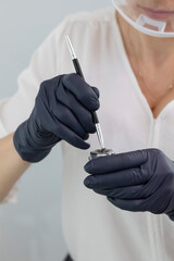 Cropped Beautician Prepares Tint for Dying Lashes During Eyelash Lamination Treatment Procedure In...