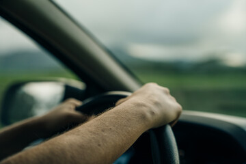 the girl correctly keeps her hands on the steering wheel in the car