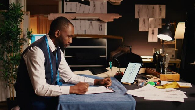 Expert tailor drawing sketch of clothes, creating vision for fashion items design in luxury atelier. Professional craftsman business owner working on designing clothes, handmade.