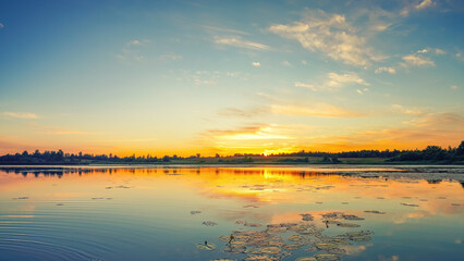Beautiful landscape with colorful sunrise over lake