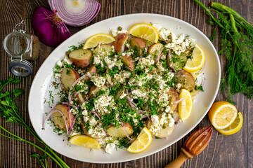 Greek Potato Salad with Feta Cheese, Fresh Herbs, and Lemon Wedges: Baby red potatoes topped with feta, dill, capers, and extra virgin olive oil