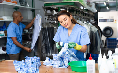 Portrait of skilled female laundry worker during daily work