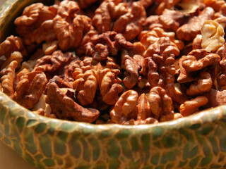 Peeled walnut lies in a bowl