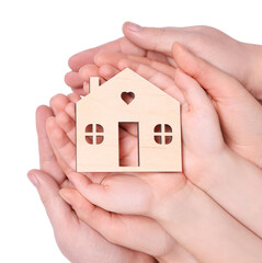 Home security concept. Family holding house model on white background, top view with space for text