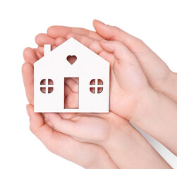 Home security concept. Woman and her little child holding house model on white background, top view with space for text