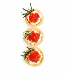 Delicious tartlets with red caviar and cream cheese on white background, top view