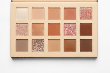 Beautiful eye shadow palette on white table, top view
