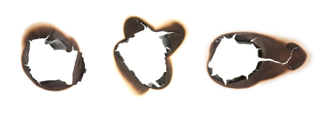 Paper with burnt holes on white background