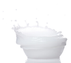 Fototapeta Milk yogurt white water spill splash from bowl up. Milk lotion pour float in mid air. Milk moisturizer explosion throw fluttering. White background isolated high speed shutter freeze motion obraz
