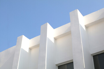 White Concrete Building Corner with blue sky. Minimal Shape Abstract Exterior Warehouse or Construction Element Concept