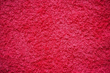 Terry towel texture. Close-up of red terry towel, may be used as background.