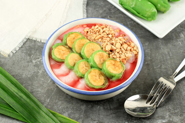 Es Pisang Ijo, Ripe Banana Rolled with Green Thin Crepes. Served with Rice Porridge