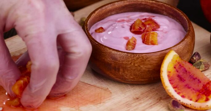 take pieces of orange, fresh yogurt with berries and fruits with red oranges, delicious dessert yogurt with orange flavor and pieces of fruit