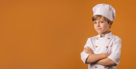  a smiling boy child dressed as a chef in soft solid dusty pink background generative ai