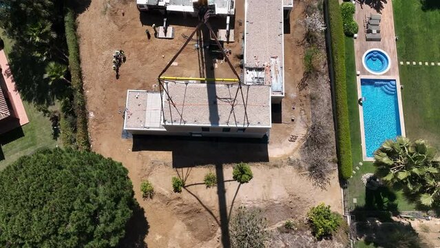 Work in progress during assembly of modular building in residential area. Aerial top-down