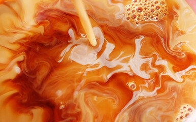 close up of milk on black tea