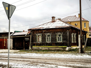 Fototapeta na wymiar old wooden house on the street of a small Ural city