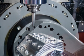 Close up scene the 5-axis machining center cutting the V8 engine cylinder block with solid ball end...