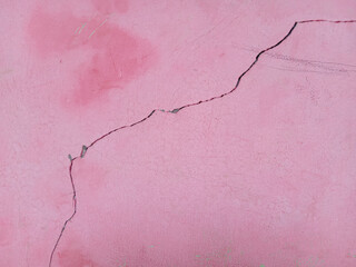 The pink walls of the house cracked during redevelopment. texture
