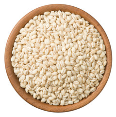 Uncooked highland barley in the wooden plate, isolated on white background, top view.