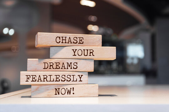 Wooden blocks with words 'Chase your dreams fearlessly now'.
