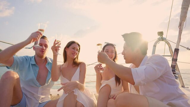 Group of diverse friends drink champagne while having a party in yacht.